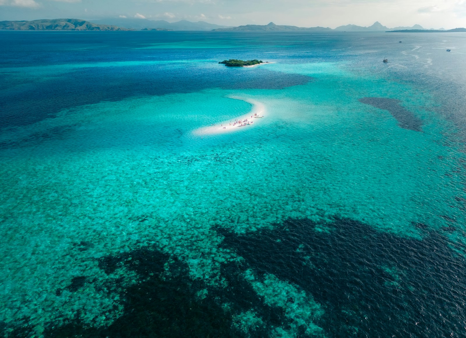 A large body of water with a small island in the middle of it